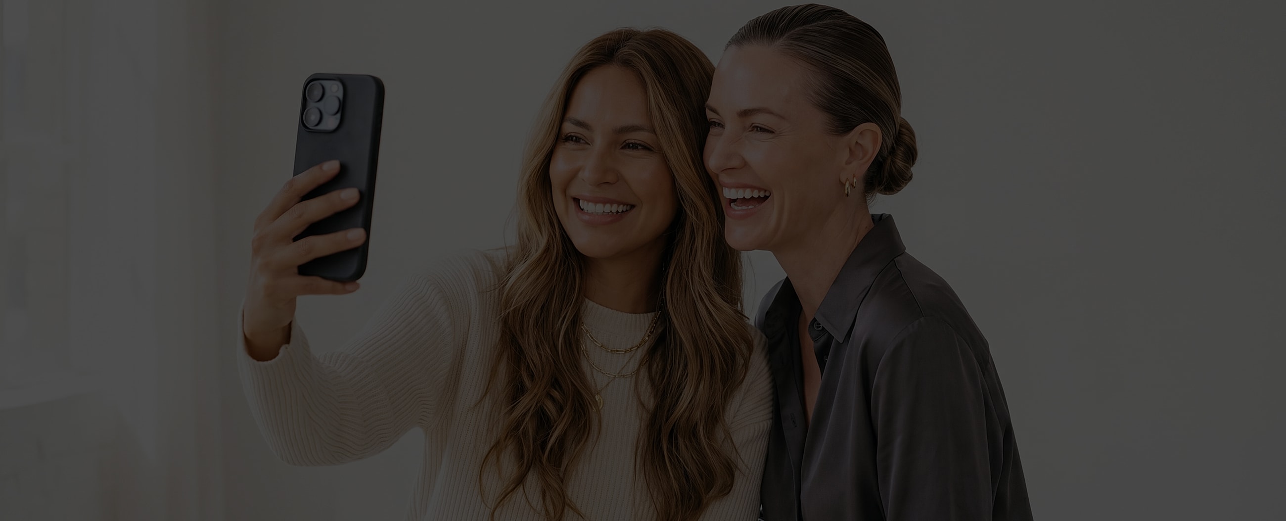 Two women taking a selfie and smiling.