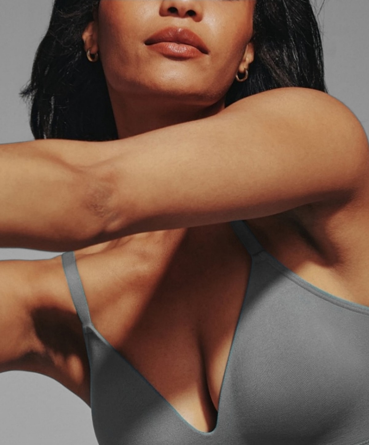 Model wearing gray spaghetti strap top.