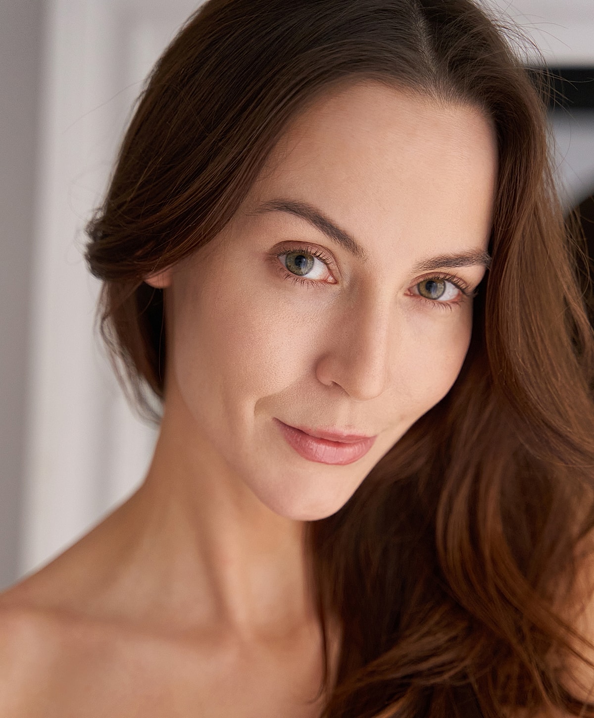 Woman with long hair and natural makeup.