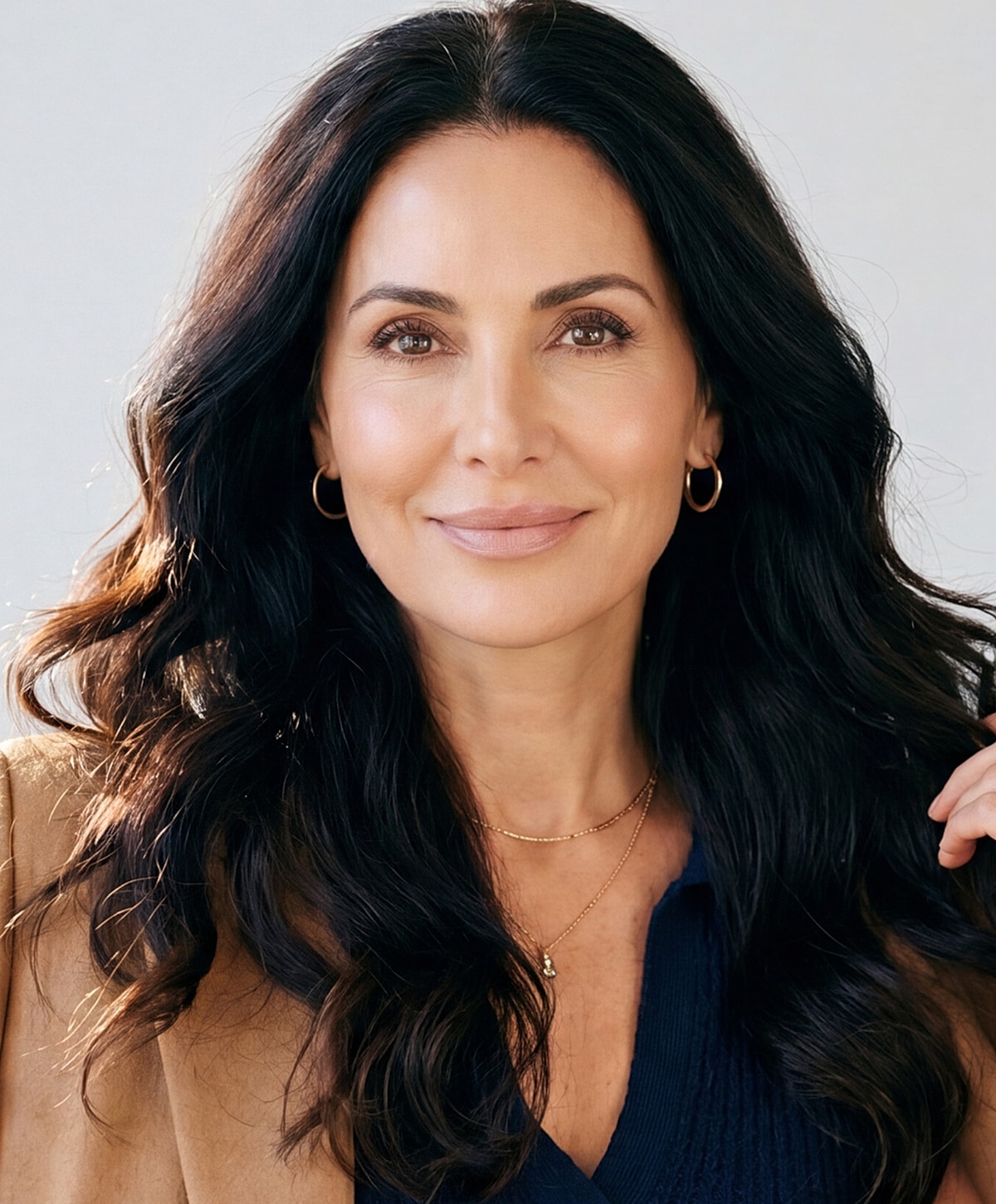 Smiling woman with long, dark hair.