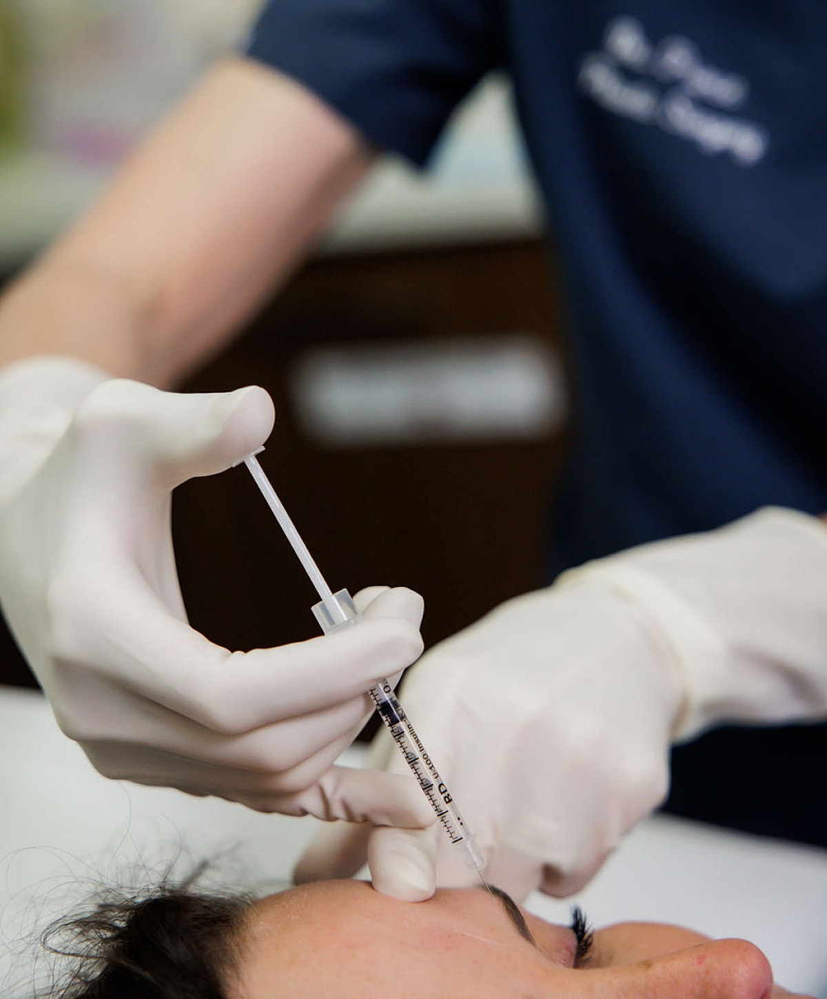 Administering injection during a cosmetic procedure.