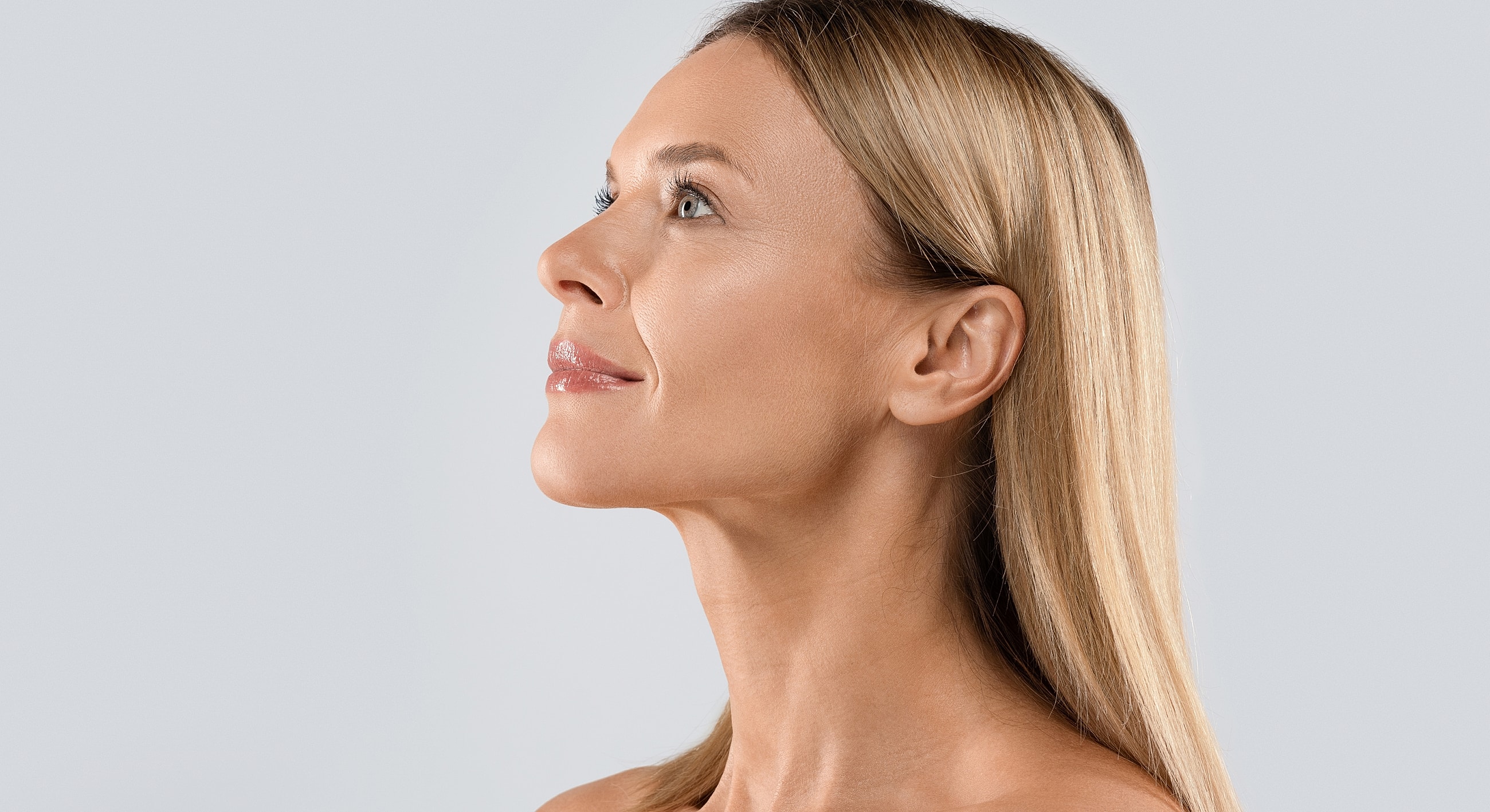 Profile of a woman with long, straight blond hair.